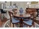 Charming dining area with a wooden table and chairs, adjacent to a modern kitchen with stainless appliances at 515 N Churton St # 203, Hillsborough, NC 27278