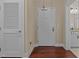Bright entryway featuring a white door, hardwood floors, and access to a bathroom with granite counters at 515 N Churton St # 203, Hillsborough, NC 27278
