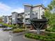 Modern apartment complex features ample parking, landscaped greenery and metal awnings at 515 N Churton St # 203, Hillsborough, NC 27278