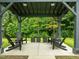 The outdoor lounge space has four chairs and is nestled in a lush green space at 515 N Churton St # 203, Hillsborough, NC 27278