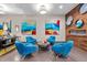 A brightly lit community lounge with modern furniture, artwork, and wood accent wall at 515 N Churton St # 203, Hillsborough, NC 27278
