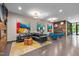 Inviting lounge with modern furniture, colorful artwork, fireplace, and wood paneled accent wall at 515 N Churton St # 203, Hillsborough, NC 27278
