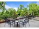 View of the outdoor patio with tables and chairs with a serene view of the surrounding nature at 515 N Churton St # 203, Hillsborough, NC 27278