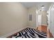 Neutral room with hardwood floors featuring a zebra rug and view of the bathroom at 515 N Churton St # 203, Hillsborough, NC 27278