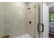 Shower in the main bathroom featuring tile surround and seamless glass door at 515 N Churton St # 203, Hillsborough, NC 27278