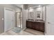 Modern bathroom with a walk-in shower, dual sinks, and granite countertops at 5321 Cambridgeshire Loop, Cary, NC 27519