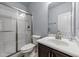 Bathroom featuring shower and tub combination with tile surround and vanity with storage at 5321 Cambridgeshire Loop, Cary, NC 27519