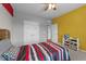 Comfortable bedroom with ceiling fan, ample closet space and playful color scheme at 5321 Cambridgeshire Loop, Cary, NC 27519