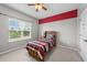 Charming bedroom with a ceiling fan and a large window letting in natural light at 5321 Cambridgeshire Loop, Cary, NC 27519