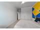 Bright bedroom featuring geometrically painted accent wall and a ceiling fan at 5321 Cambridgeshire Loop, Cary, NC 27519