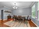 Cozy dining room with hardwood floors, elegant chandelier, and large windows for natural light at 5321 Cambridgeshire Loop, Cary, NC 27519
