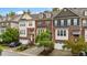 Charming brick townhome with attached garages, front stairs, and manicured landscaping at 5321 Cambridgeshire Loop, Cary, NC 27519