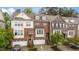 Charming brick townhome with attached garages, front stairs, and manicured landscaping at 5321 Cambridgeshire Loop, Cary, NC 27519
