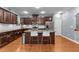 Modern kitchen features granite countertops, stainless steel appliances, and dark wood cabinets at 5321 Cambridgeshire Loop, Cary, NC 27519