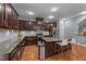 Stylish kitchen featuring granite countertops, stainless steel appliances, and island with barstool seating at 5321 Cambridgeshire Loop, Cary, NC 27519