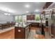 Modern kitchen features granite countertops, stainless steel appliances, and dark wood cabinets at 5321 Cambridgeshire Loop, Cary, NC 27519