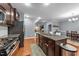 Kitchen with island, stainless appliances and view to living room and dining area at 5321 Cambridgeshire Loop, Cary, NC 27519