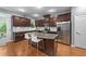 Modern kitchen with stainless steel appliances, granite counters, and a kitchen island with seating at 5321 Cambridgeshire Loop, Cary, NC 27519