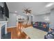 Open-concept living room with hardwood floors, fireplace, and views to kitchen and staircase at 5321 Cambridgeshire Loop, Cary, NC 27519