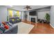 Bright living room with fireplace, ceiling fan, and hardwood floors at 5321 Cambridgeshire Loop, Cary, NC 27519