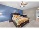 Comfortable main bedroom with ample natural light, en-suite bathroom and ceiling fan at 5321 Cambridgeshire Loop, Cary, NC 27519