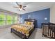 Comfortable main bedroom with ample natural light, en-suite bathroom and ceiling fan at 5321 Cambridgeshire Loop, Cary, NC 27519