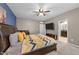 Comfortable main bedroom with ample natural light, en-suite bathroom and ceiling fan at 5321 Cambridgeshire Loop, Cary, NC 27519