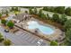 Aerial view of the community pool area featuring lounge chairs, umbrellas, and manicured landscaping at 5321 Cambridgeshire Loop, Cary, NC 27519