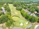 Aerial view of golf course surrounded by trees and residential area at 5512 Grand Traverse Dr, Raleigh, NC 27604