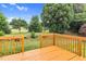 Exterior view of the back deck overlooking the lush green lawn and mature trees at 5512 Grand Traverse Dr, Raleigh, NC 27604