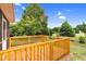 Exterior view of a wood back deck overlooking a large, well-maintained lawn and mature trees at 5512 Grand Traverse Dr, Raleigh, NC 27604