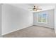 An empty bedroom featuring carpet floors, ceiling fan, and a window at 5512 Grand Traverse Dr, Raleigh, NC 27604
