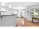 Open dining area with hardwood floors, a modern chandelier, and large windows at 5512 Grand Traverse Dr, Raleigh, NC 27604