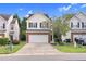 Charming townhouse with a two-car garage, brick accents, and well-maintained front yard at 5512 Grand Traverse Dr, Raleigh, NC 27604