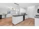 Kitchen island with granite counters, white cabinets, stainless steel sink, and black dishwasher at 5512 Grand Traverse Dr, Raleigh, NC 27604