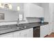 Kitchen with granite counters, white cabinets, stainless steel sink, and black dishwasher at 5512 Grand Traverse Dr, Raleigh, NC 27604