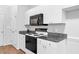 Updated kitchen with white cabinets, black microwave, granite counters, and stainless steel appliances at 5512 Grand Traverse Dr, Raleigh, NC 27604