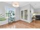 Bright living room with hardwood floors, fireplace, chandelier, and access to the backyard at 5512 Grand Traverse Dr, Raleigh, NC 27604