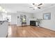 Cozy living room with a fireplace, hardwood floors, and a ceiling fan at 5512 Grand Traverse Dr, Raleigh, NC 27604