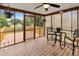Cozy screened porch with wood floors, ceiling fan, and outdoor seating area at 5512 Grand Traverse Dr, Raleigh, NC 27604