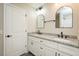 Bathroom vanity featuring double sinks, granite countertop, and two arched mirrors above at 5576 Foothills Ct, Snow Camp, NC 27349