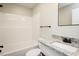 A combined shower and bathtub with a white showerhead and a granite sink top at 5576 Foothills Ct, Snow Camp, NC 27349