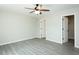A bright bedroom with a ceiling fan and two white doors, one of which leads to a closet at 5576 Foothills Ct, Snow Camp, NC 27349
