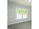Bright bedroom featuring a window with natural light and stylish gray flooring at 5576 Foothills Ct, Snow Camp, NC 27349