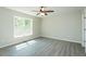 This bedroom has a ceiling fan, hardwood floors, and a bright window to give natural lighting at 5576 Foothills Ct, Snow Camp, NC 27349