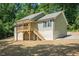 Inviting two-story home featuring a charming porch and situated on a spacious lot surrounded by lush trees at 5576 Foothills Ct, Snow Camp, NC 27349