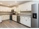 Modern kitchen with white cabinets, stainless steel appliances, and gray countertops at 5576 Foothills Ct, Snow Camp, NC 27349
