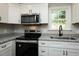 Close up on the kitchen featuring stainless steel appliances and gray countertop at 5576 Foothills Ct, Snow Camp, NC 27349
