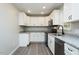 Modern kitchen featuring white cabinets, gray countertop, and stainless steel appliances at 5576 Foothills Ct, Snow Camp, NC 27349