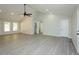 Open living room featuring vaulted ceiling, gray flooring, and natural light at 5576 Foothills Ct, Snow Camp, NC 27349